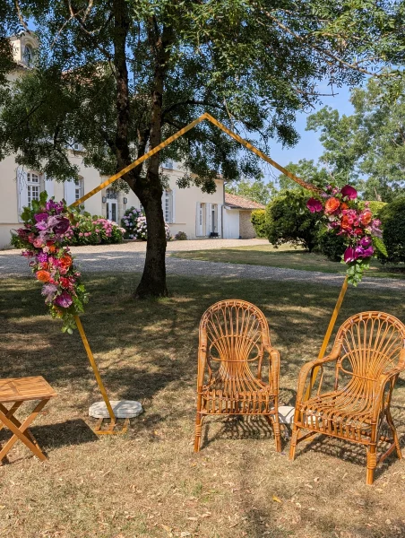 Geometric floral arch with colourful floral compositions, sophisticated rustic style.