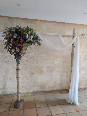 Asymmetrical sophisticated country-style floral arch with roses, delphiniums and eucalyptus for Ilonna & Quentin's wedding.