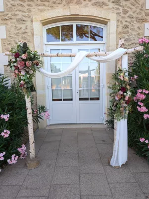 Sophisticated rustic floral arch with burgundy roses and pink carnations for Emma & Valient's wedding