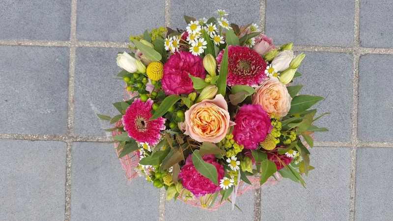 Rustic wedding tossing bouquet, with peach roses, fuchsia gerberas, daisies and yellow craspedia.
