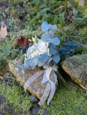 Petit bouquet de mariée à lancer, style bohème, avec roses blanches, gypsophile et feuillage eucalyptus frais.