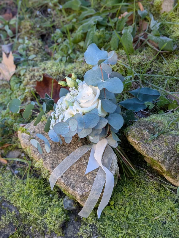 Petite bridal tossing bouquet, Bohemian style, with white roses, gypsophila and fresh eucalyptus foliage.