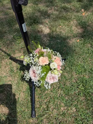 Small sophisticated country toss bouquet with roses, carnations, and gypsophila for a wedding.
