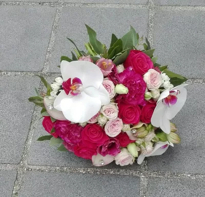 Bouquet de mariée classique, avec des orchidées phalaenopsis blanches, des roses fuchsia et roses claires, et du dianthus.