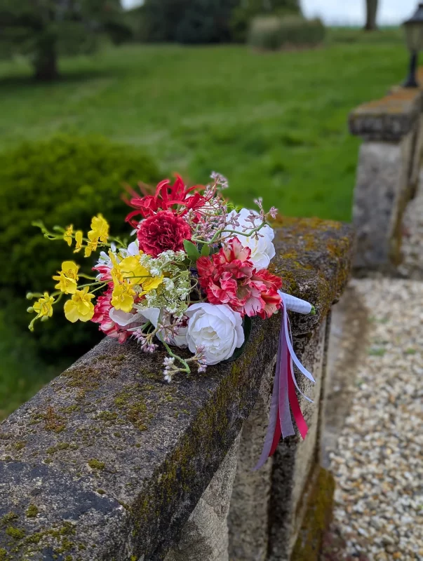 Bridal bouquet, exotic and classic, with yellow orchids, white roses and red carnations for Sebastien's wedding.