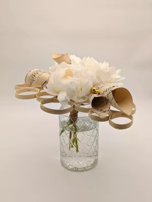 Exquisite minimalist bridal bouquet, featuring white peonies and delicate sheet music paper creations.