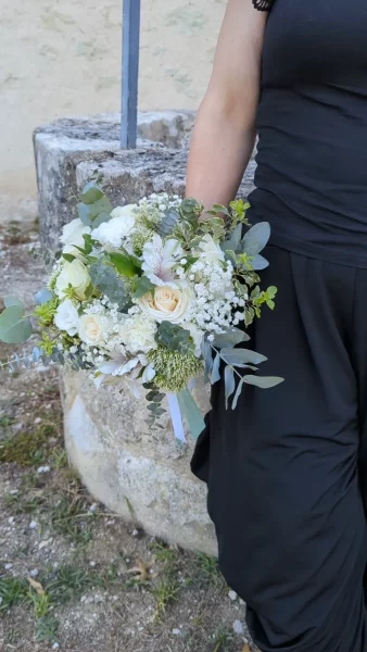 Organic romantic bridal bouquet with cream roses, gypsophila, and eucalyptus for a wedding.