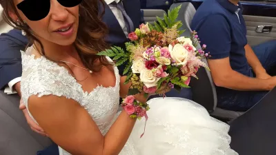 Bridal bouquet, rustic-elegant, composed of cream and pale pink roses, delicate astilbe, and ferns.