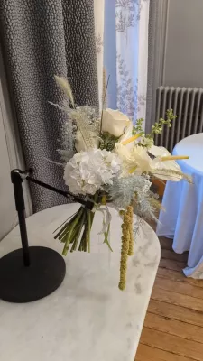 Romantic organic bridal bouquet with cream roses, hydrangeas, and white anthuriums, silvery foliage.
