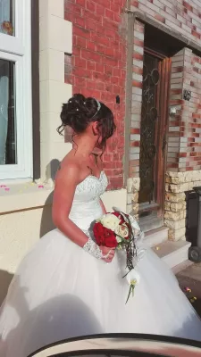 Gorgeous classic bridal bouquet with red and white roses, orchids, and green foliage for an autumn wedding.