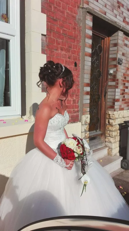 Gorgeous classic bridal bouquet with red and white roses, orchids, and green foliage for an autumn wedding.