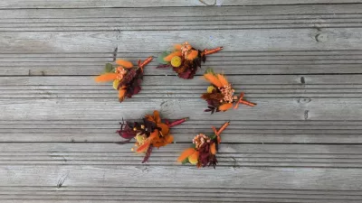 Sophisticated rustic buttonholes with dried orange, red, and yellow flowers, burgundy foliage for wedding.