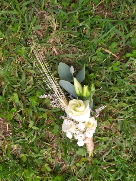 Boutonnière de marié champêtre avec rose blanche, blé, eucalyptus et gypsophile pour le mariage de Vanessa à Donnezac.