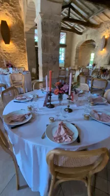 Table centrepiece featuring pink dahlias, orange roses, pink pampas grass and coral candles, sophisticated country style.