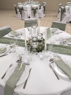 Sophisticated country-style table centrepiece with gypsophila, eucalyptus, and floating candles.