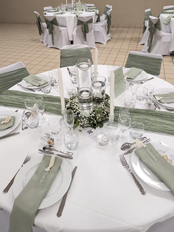 Sophisticated country-style table centrepiece with gypsophila, eucalyptus, and floating candles.