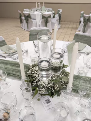 Sophisticated country-style table centrepiece with gypsophila, eucalyptus, and floating candles.