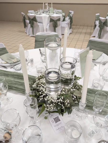 Sophisticated country-style table centrepiece with gypsophila, eucalyptus, and floating candles.