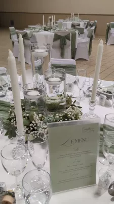 Sophisticated country-style table centrepiece with gypsophila, eucalyptus, and floating candles.