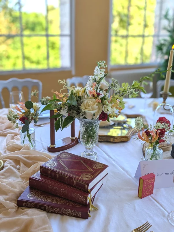 Sophisticated rustic table centrepiece with cream rose, white delphinium and orange alstroemeria for a wedding.