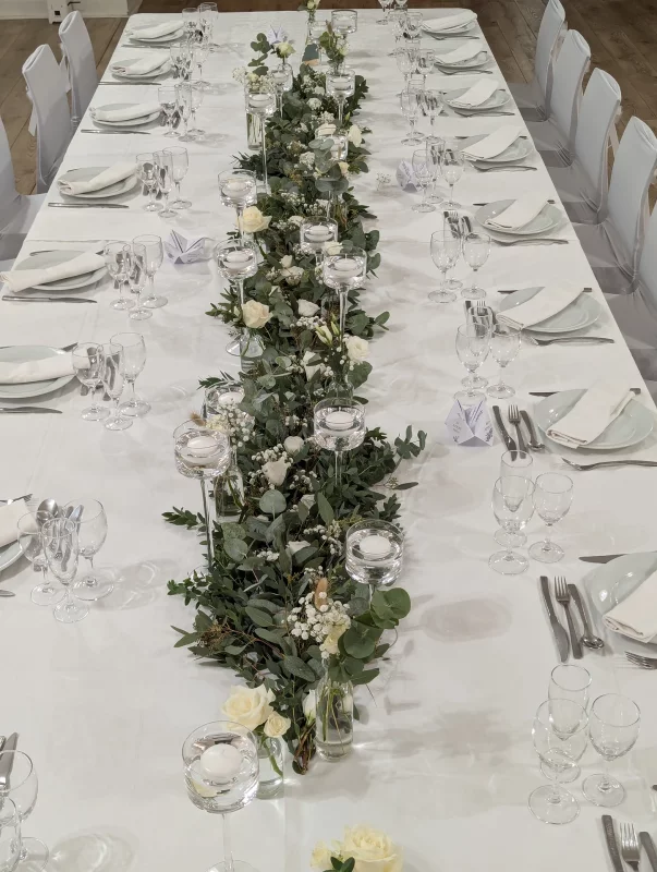 Bohemian table centrepiece featuring white roses, eucalyptus and pampas grass for an elegant wedding at Château Bone in Gauriac.