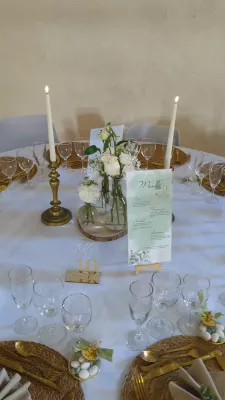 Sophisticated country-style table centrepiece with cream roses and gypsophila for a wedding.