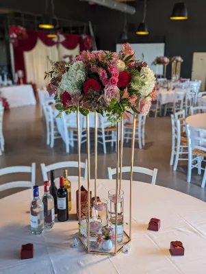 Sophisticated country-style table centrepiece with roses, hydrangeas, alstroemerias, and chrysanthemums.