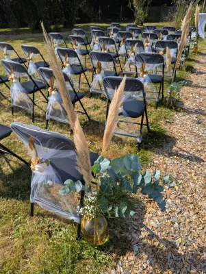 Wedding ceremony aisle decoration with pampas grass and eucalyptus adorning the chairs
