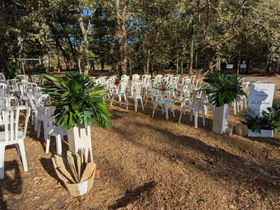 Outdoor wedding ceremony styling with tropical floral arrangements and a welcome sign.