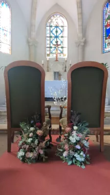 Organic romantic floral arrangements with white and pink hydrangeas, green foliage for wedding ceremony.
