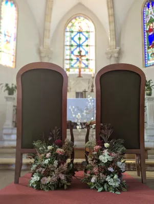 Sophisticated rustic floral arrangements with burgundy roses and pink carnations for ceremony