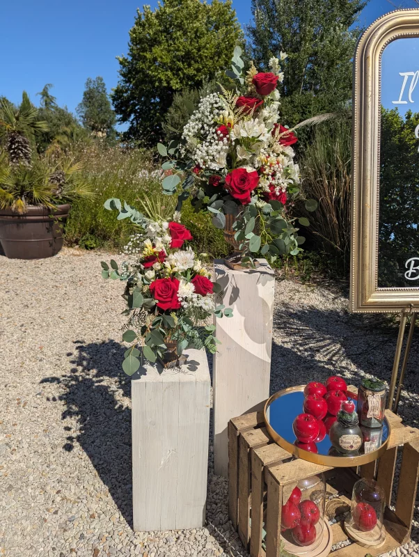 Country-chic floral columns with red roses, white alstroemerias and eucalyptus, wedding.