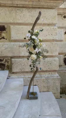 Romantic organic floral design with white roses, eucalyptus and gypsophila for a wedding.