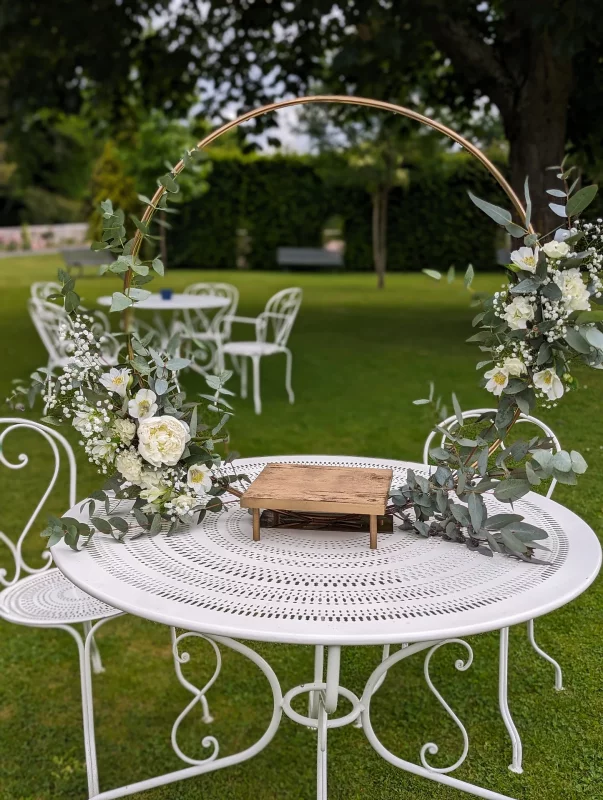 Ceremony Decoration featuring a golden circle adorned with white roses, gypsophila and eucalyptus, in a classic style.