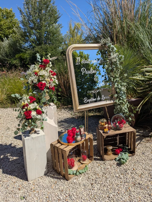 Sophisticated rustic Welcome sign with red roses, white alstroemerias and eucalyptus, for a wedding.