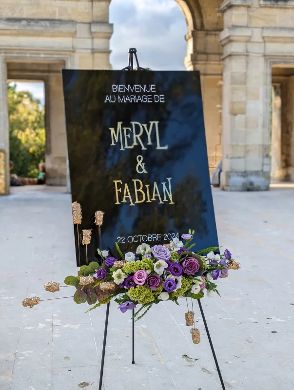 Contemporary floral design for a wedding welcome sign, mauve, green, and white roses and lisianthus, 22 October 2024.