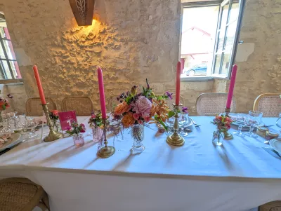 Head Table with floral table centrepieces, coral candles and gold candelabras, in a sophisticated rustic style.