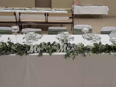 Sophisticated country-style head table decoration with eucalyptus and gypsophila garland.