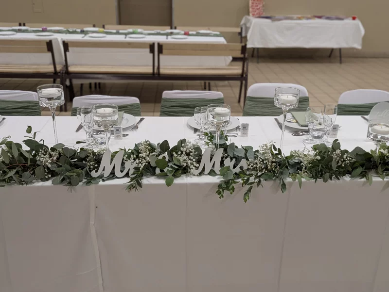 Sophisticated country-style head table decoration with eucalyptus and gypsophila garland.