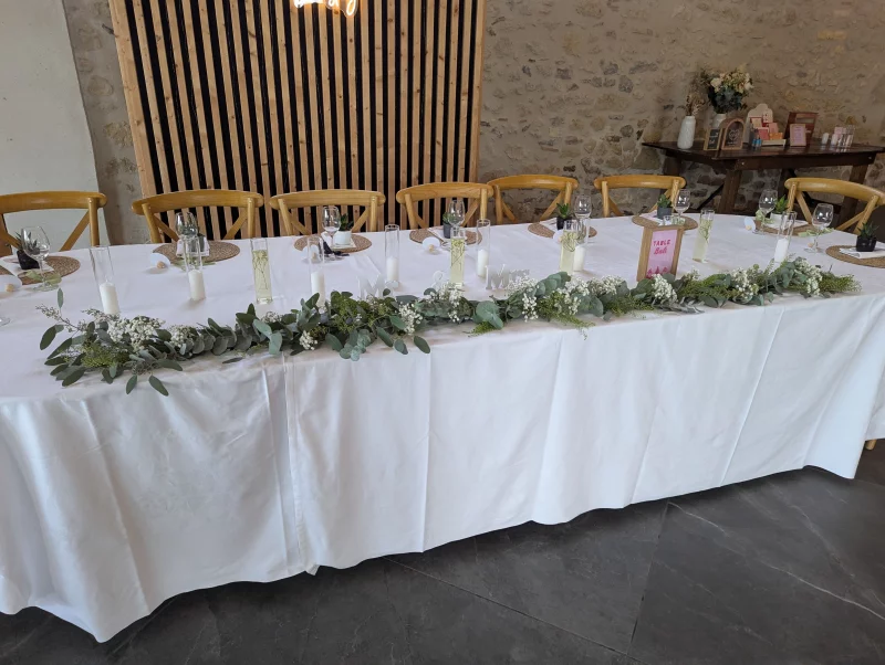 Sophisticated country-style head table with eucalyptus and gypsophila garland, Domaine Le Herre.