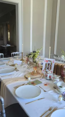 Sophisticated rustic Head Table with purple flowers, red roses and foliage, wedding.