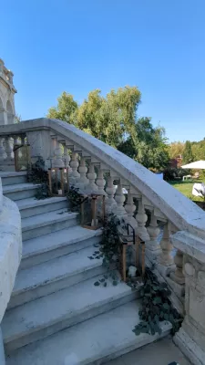 Romantic organic foliage with eucalyptus along the château staircase, wedding.