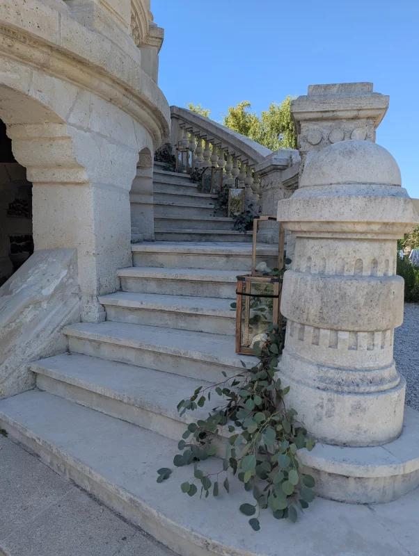 Romantic organic eucalyptus greenery along the château's staircase, wedding.