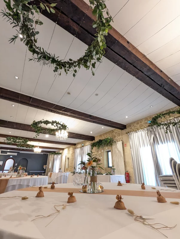 Hanging greenery decoration with eucalyptus and ruscus, creating a sophisticated rustic atmosphere.